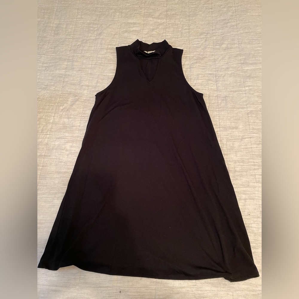 Black mid thigh dress with collard neck and triangle opening around chest